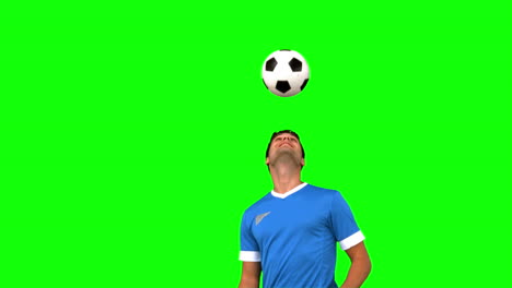 Man-juggling-a-football-with-his-head-on-green-screen