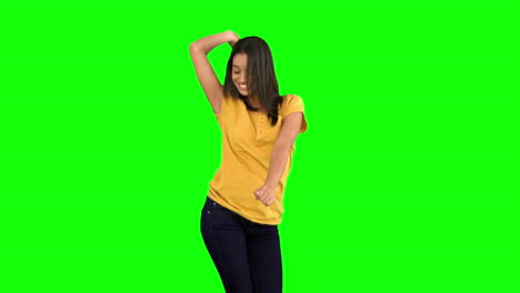 Woman-dancing-with-arms-raised-on-green-screen