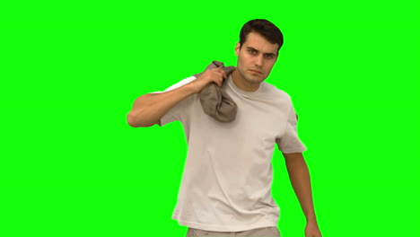 Handsome-man-holding-his-coat-on-green-screen