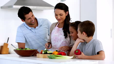 Mother-showing-children-how-to-chop-vegetables