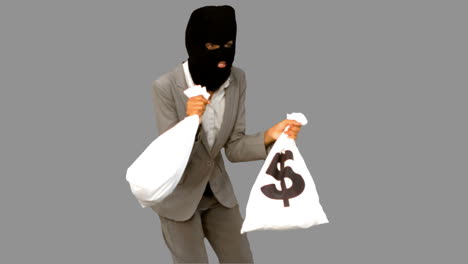 Burglar-holding-money-bags-on-grey-screen