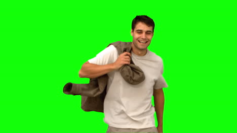 Man-holding-his-coat-on-green-screen