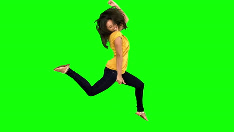 Cheerful-woman-jumping-with-legs-and-arms-raised