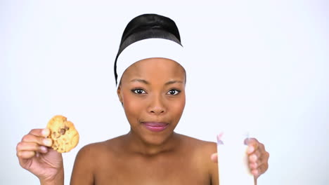 Attractive-woman-drinking-milk-and-holding-biscuit