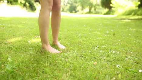Female-legs-on-the-grass-walking-away