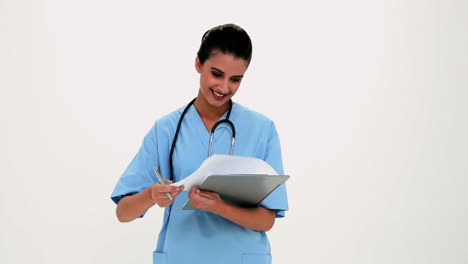 Cheerful-beautiful-nurse-filling-a-report