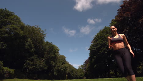 Toned-brunette-running-on-grass