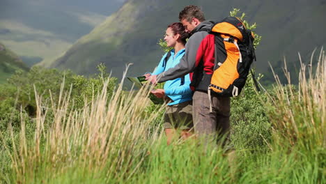 Active-couple-hiking-together-and-reading-map