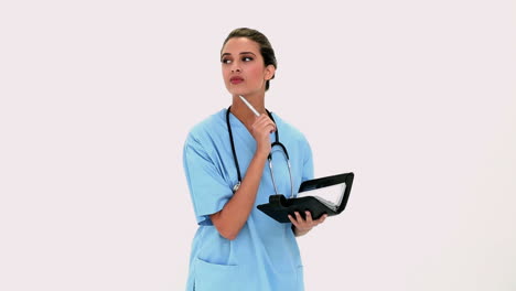 Pensive-beautiful-nurse-checking-a-schedule