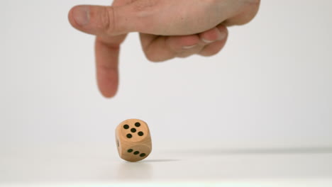 Hand-letting-twist-a-wooden-dice