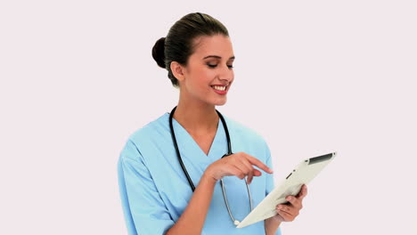 Thoughtful-beautiful-nurse-using-a-tablet-pc