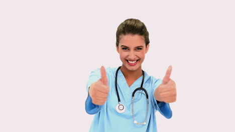 Happy-beautiful-nurse-giving-thumbs-up