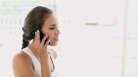 Fit-young-woman-talking-on-the-phone