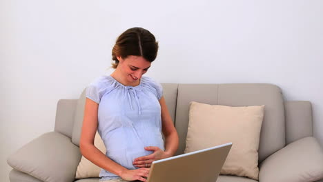 Schwangere-Frau-Mit-Ihrem-Laptop-Auf-Der-Couch