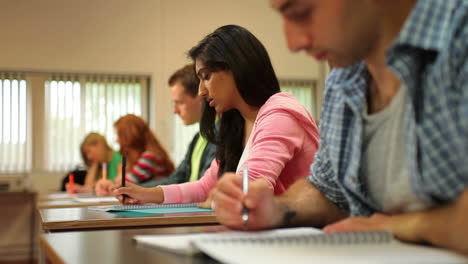 Concentrating-students-taking-notes-in-class