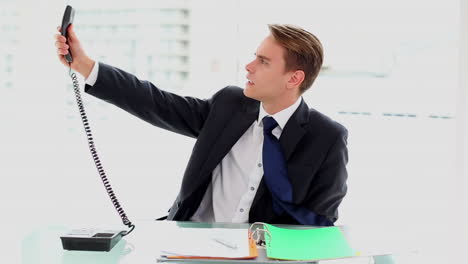 Young-businessman-working-at-his-desk