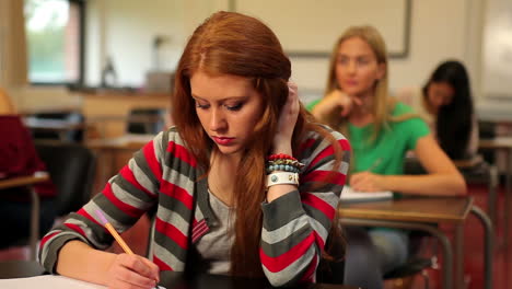 Blonde-student-thinking-in-class