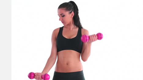 Toned-smiling-brunette-working-out-with-dumbbells