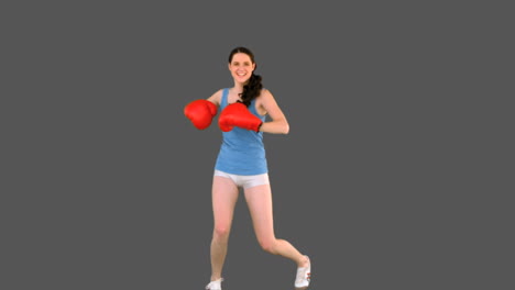 Young-model-in-sportswear-and-boxing-gloves-turning-round