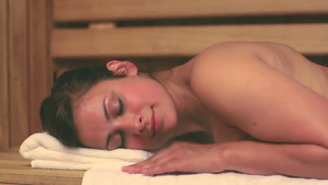 Brunette-relaxing-in-the-sauna