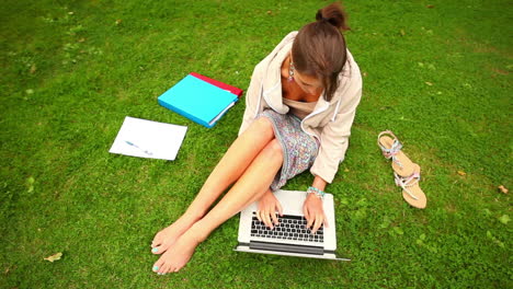 Student-Arbeitet-Mit-Laptop-Auf-Gras-Sitzend