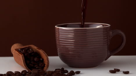 Hot-coffee-pouring-into-brown-cup
