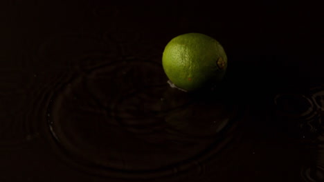 Lime-dropping-on-wet-black-surface