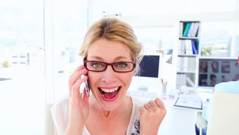 Excited-businesswoman-getting-good-news-over-the-phone