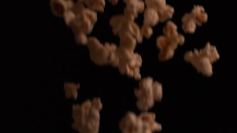 Popcorn-falling-against-black-background