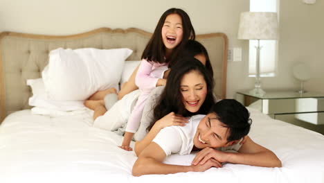 Silly-family-playing-on-the-bed