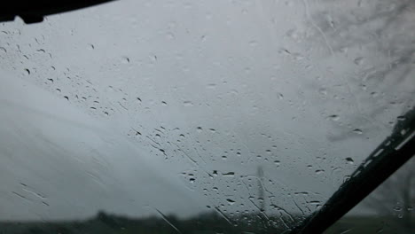 Windscreen-wiper-wiping-rain-away-from-car-window