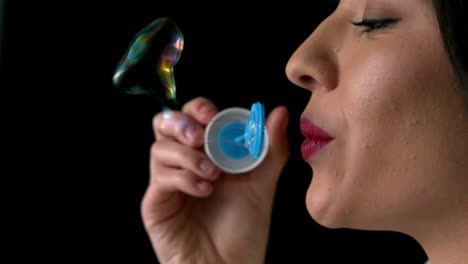 Woman-blowing-bubbles-close-up