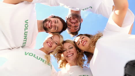 Team-of-volunteers-smiling-down-at-camera