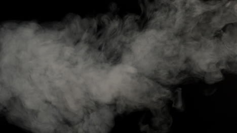 Smoke-blowing-against-black-background