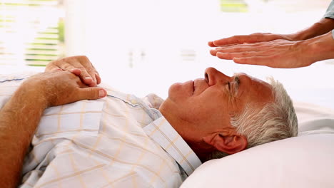 Senior-man-getting-reiki-therapy