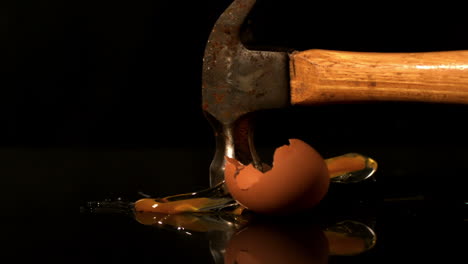 Hammer-smashing-egg-on-black-background