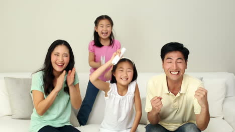 Cute-family-playing-video-games-on-the-couch