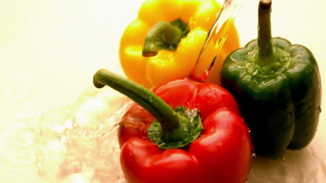 Water-pouring-on-selection-of-peppers