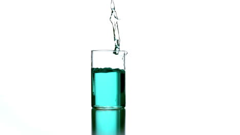 Beaker-with-blue-liquid-falling-on-white-background