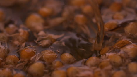 Water-pouring-over-dried-herbal-tea-swirling-in-water