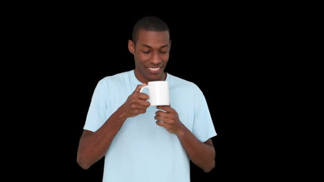 Casual-young-man-enjoying-cup-of-coffee