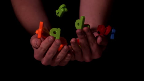 Hands-tossing-alphabet-letters-in-the-air