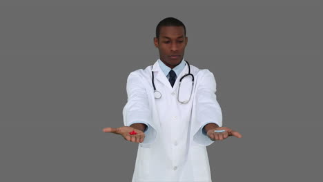 Serious-young-doctor-showing-tablets-to-camera