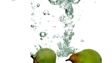 Pears-plunging-into-water-on-white-background