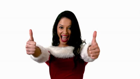 Pretty-brunette-in-santa-outfit-showing-thumbs-up