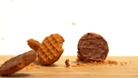 Biscuits-falling-and-breaking-on-wooden-table