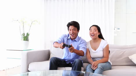 Asian-man-playing-video-games-with-girlfriend