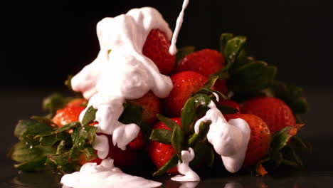 Whipped-cream-pouring-onto-strawberries