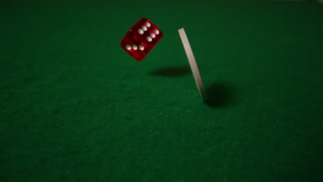 White-chip-spinning-and-red-dice-falling-on-casino-table