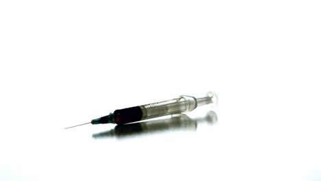 Syringe-spinning-on-white-surface